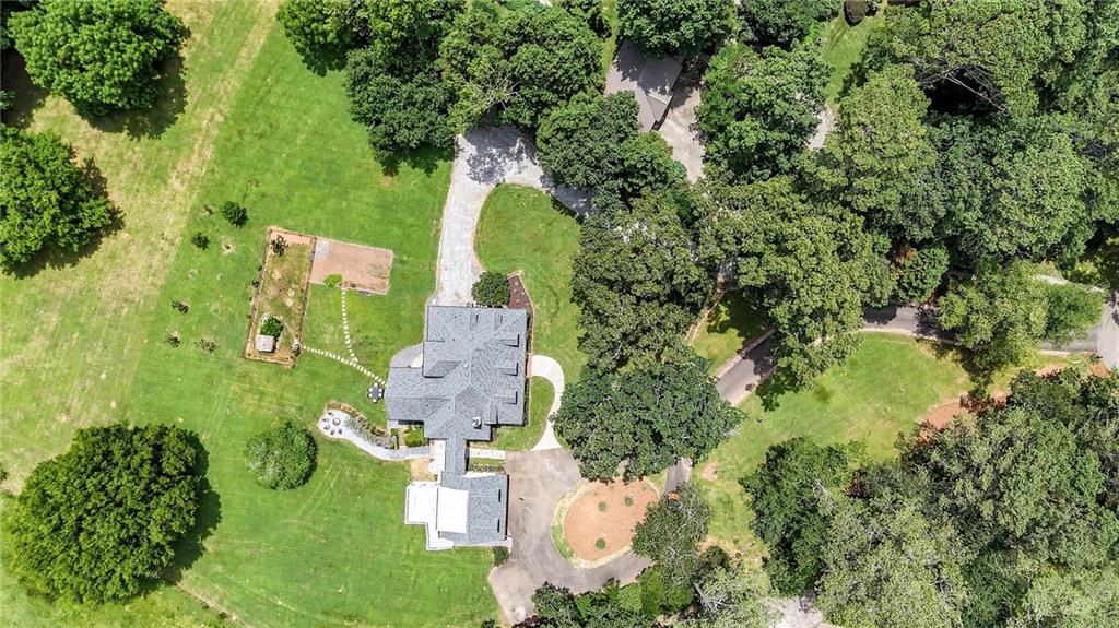 548 Tamarack Trail Canton, GA 30115 - Photo 10 of 83 an aerial view of a house with a garden and trees