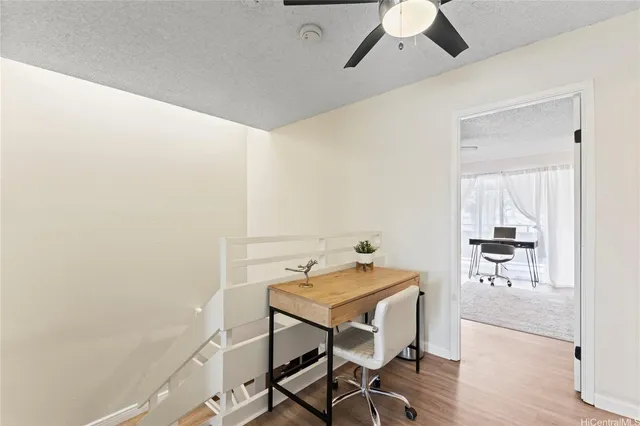 a view of a room with furniture and wooden floor