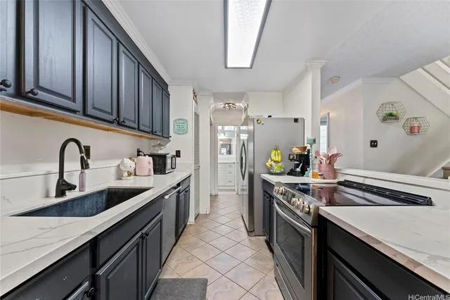 a kitchen with stainless steel appliances granite countertop a sink stove and refrigerator