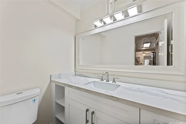 a bathroom with a sink a toilet and a mirror