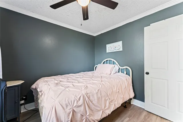 a bedroom with a bed and a ceiling fan