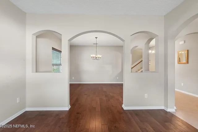 a kitchen with kitchen island granite countertop a sink a counter space and cabinets