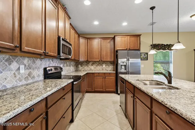 a bathroom with a double vanity sink a large mirror and a bathtub