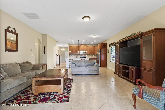 a living room with furniture and a flat screen tv