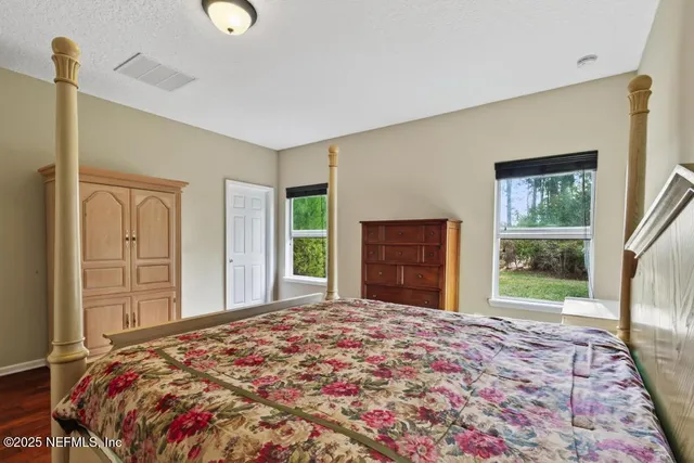 a bedroom with a bed and a potted plant