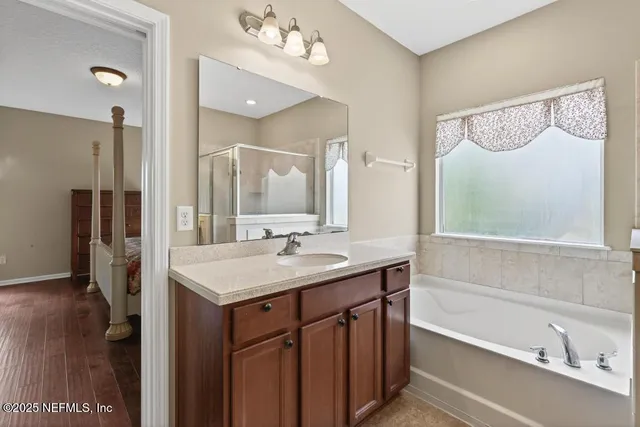 a view of a chair and table in backyard of the house