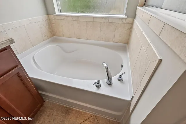 a view of a grassy field with trees in the background