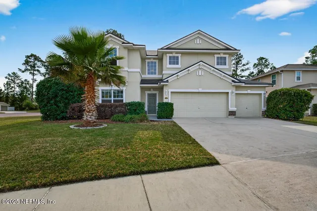 a view of a hallway with wooden floor and a living room