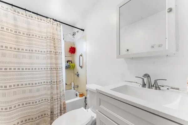 a bathroom with a sink toilet and shower