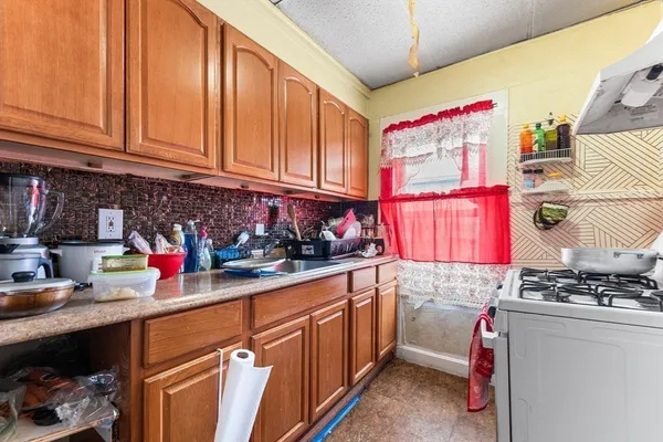 a kitchen with stainless steel appliances granite countertop a sink stove and cabinets