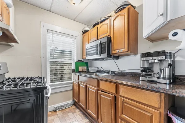 a kitchen with stainless steel appliances granite countertop a sink stove and cabinets