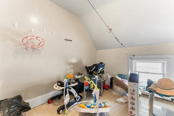 a bedroom with furniture and a flat screen tv