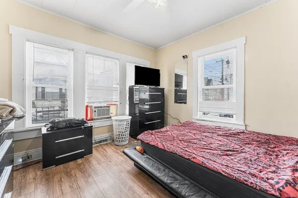 a bed sitting in a bedroom next to a window