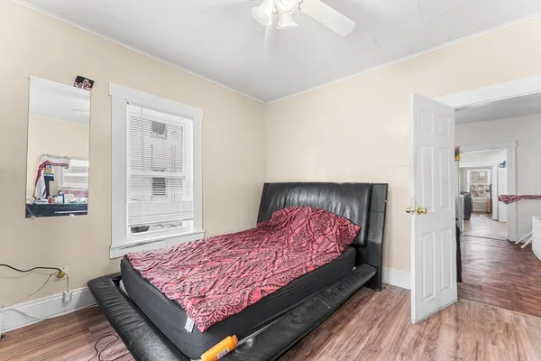 a bedroom with a bed and a chandelier