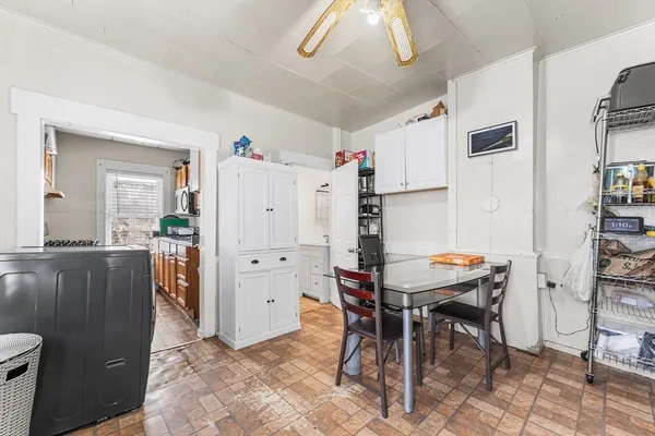 a kitchen with stainless steel appliances kitchen island granite countertop a refrigerator and a stove top oven