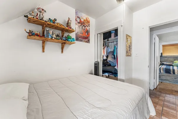 a bedroom with a bed and closet