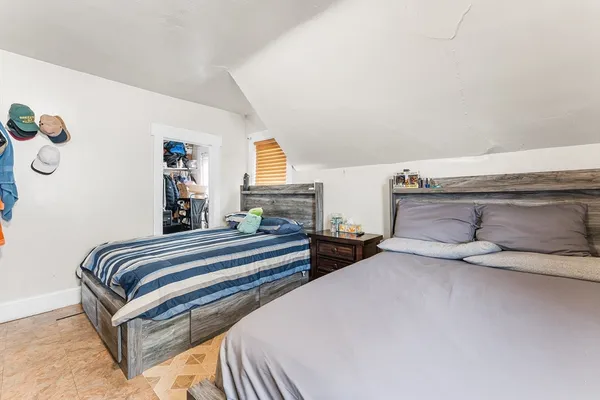 a bedroom with a bed and a couch