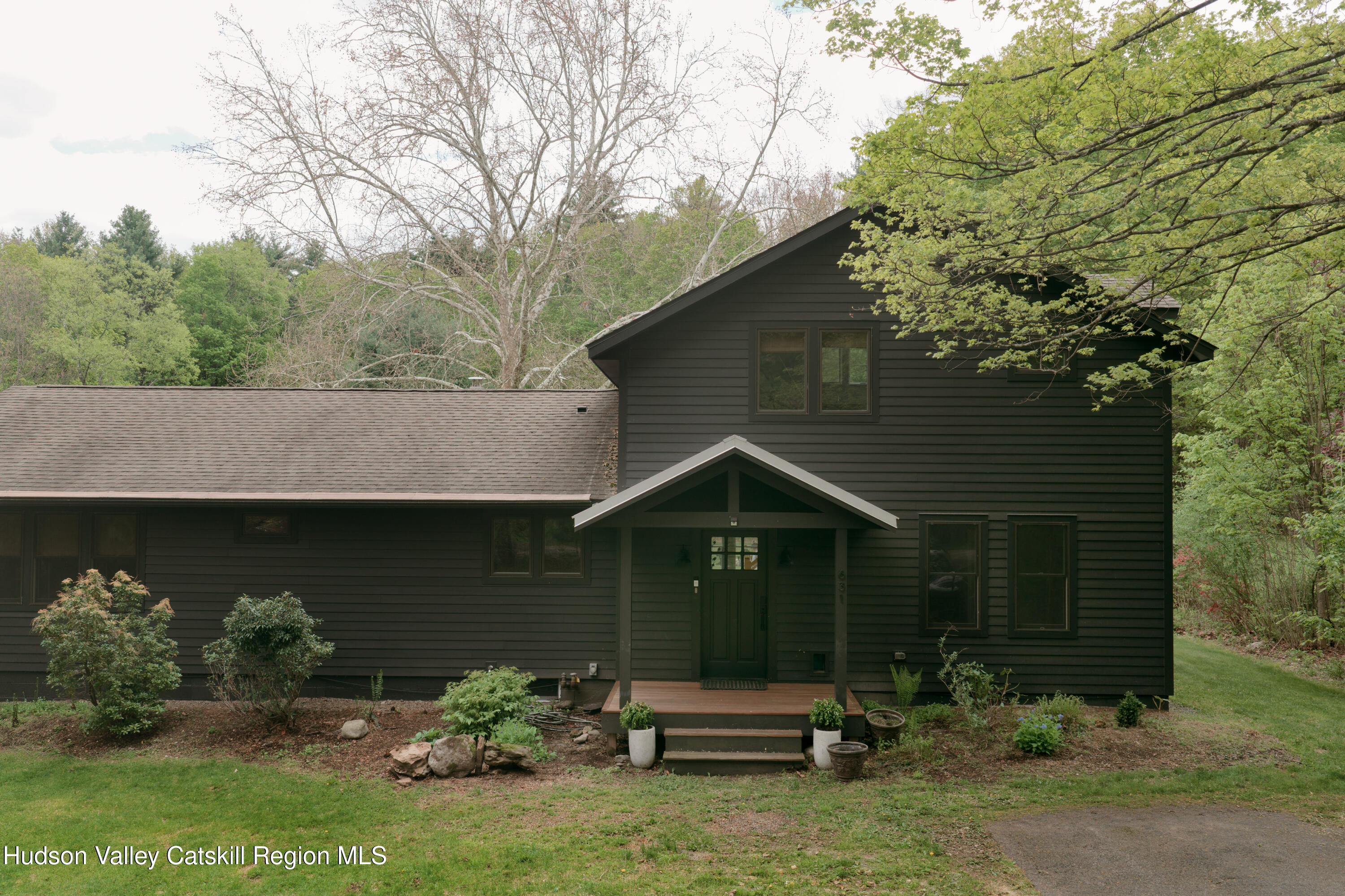 631 Granite Road Kerhonkson, NY 12446 - Photo 1 of 27 a front view of a house with garden