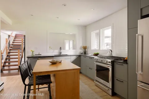 a kitchen with stainless steel appliances cabinets stove and table