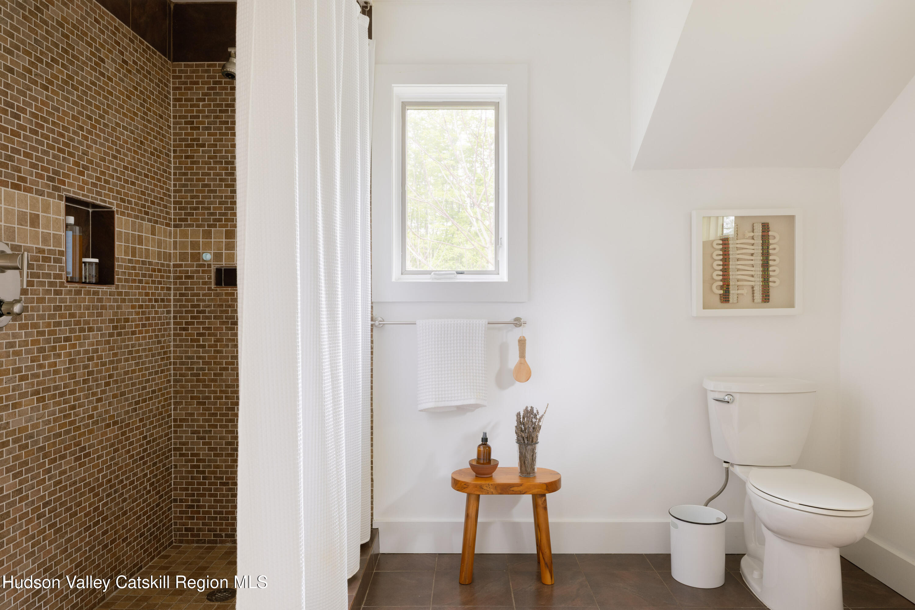 631 Granite Road Kerhonkson, NY 12446 - Photo 24 of 27 a bathroom with a toilet a sink and a mirror