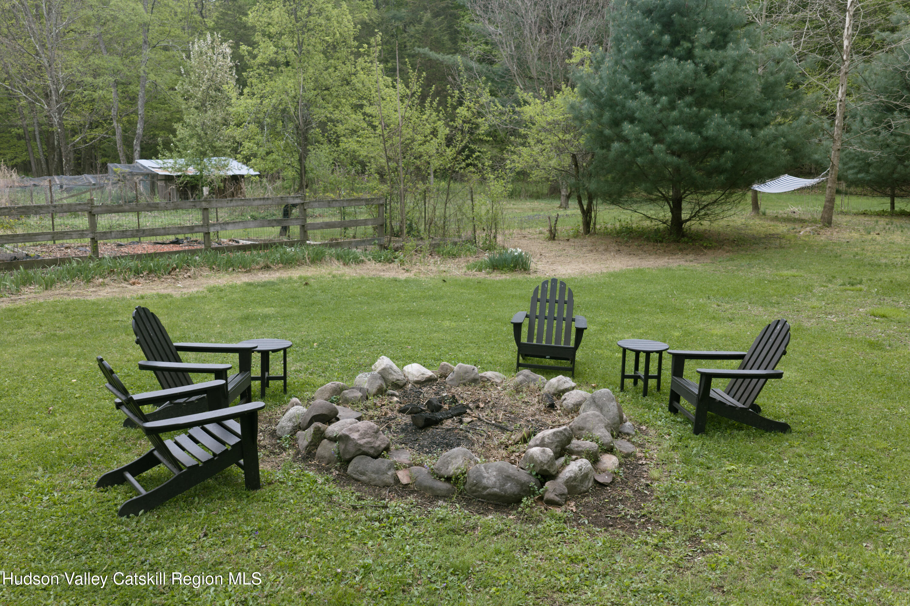 631 Granite Road Kerhonkson, NY 12446 - Photo 27 of 27 a garden with a bench and some trees
