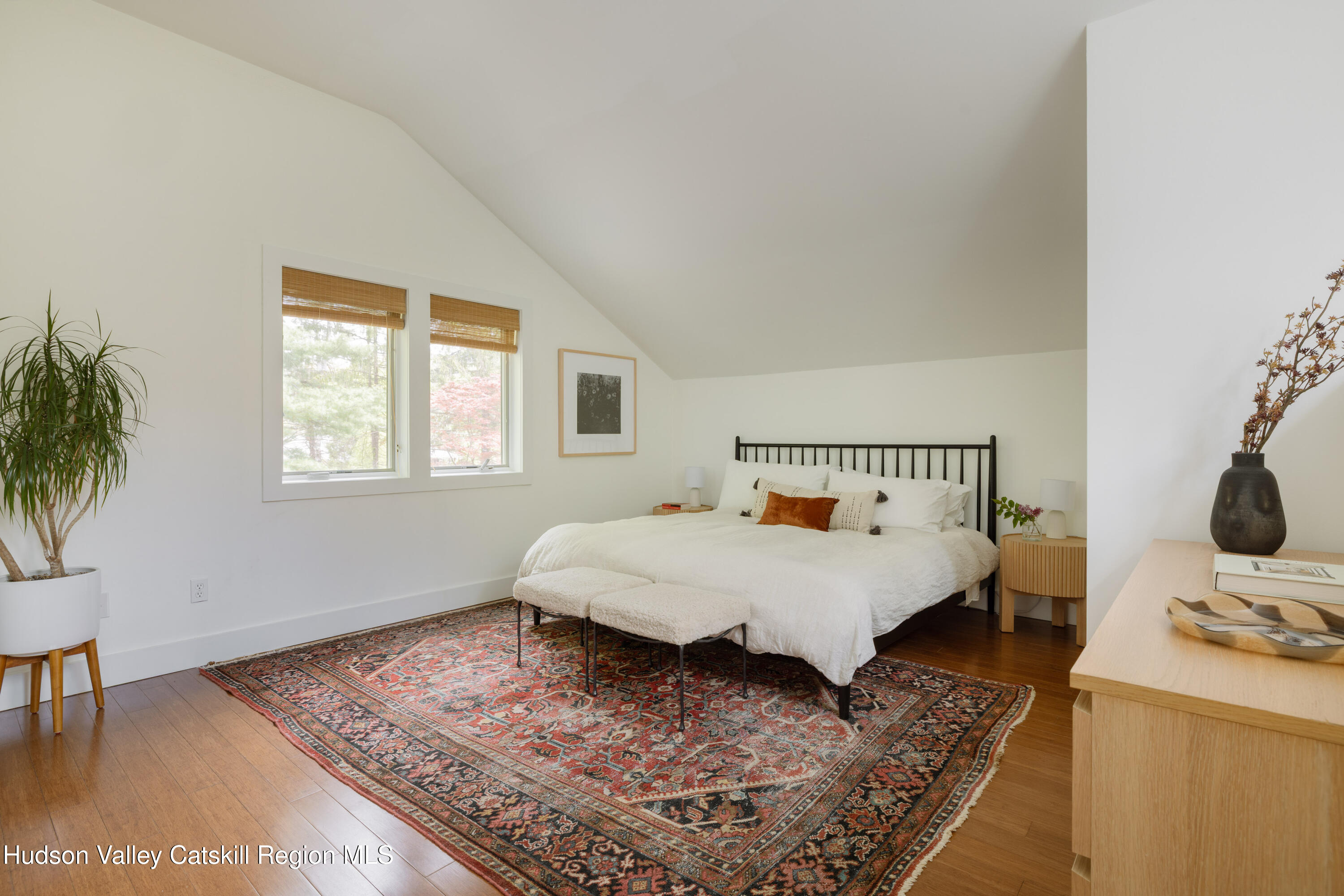 631 Granite Road Kerhonkson, NY 12446 - Photo 5 of 27 a bed sitting in a bedroom next to a window with a lamp on table and chair