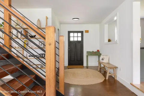 a view of a livingroom with furniture and staircase