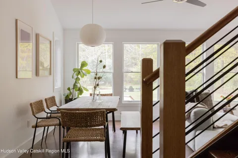 a view of a dining room with furniture and a window