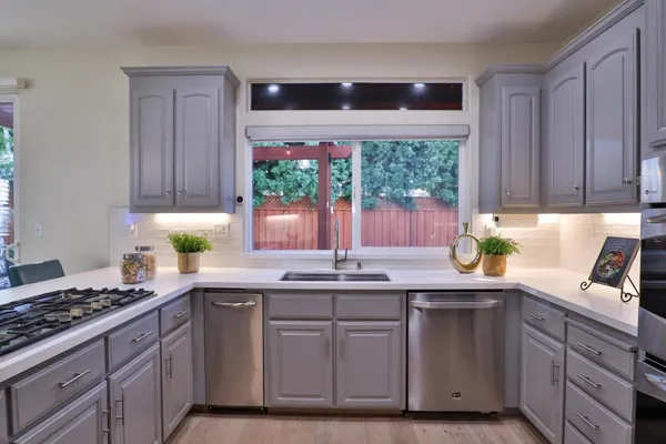 a kitchen with a sink and cabinets