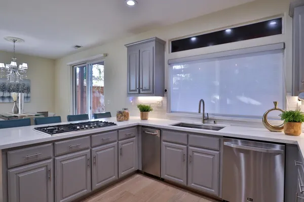 a kitchen with stainless steel appliances a stove a sink a refrigerator and cabinets