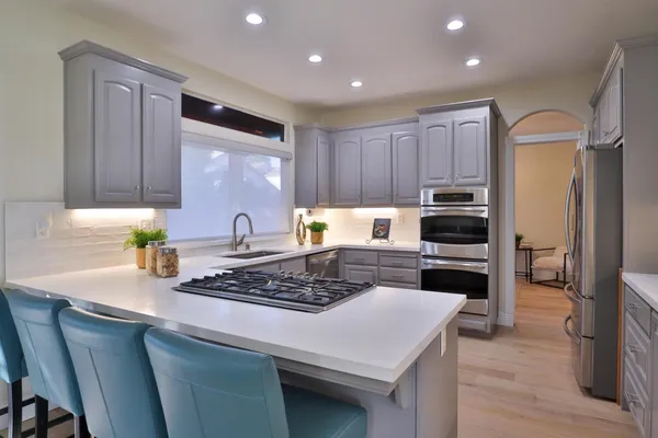 a kitchen with a stove a refrigerator and a refrigerator