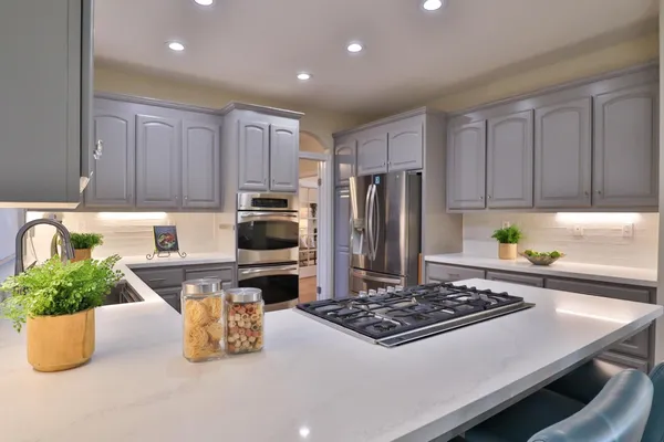 a view of a dining room with furniture a chandelier and wooden floor