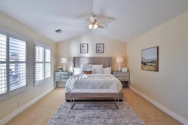 a bedroom with a large bed and a window