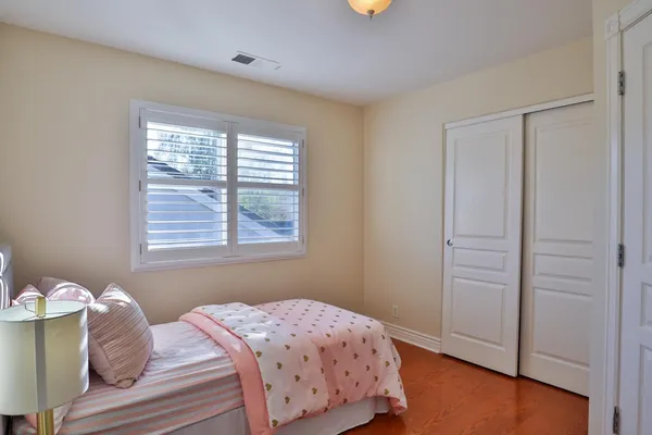 a bedroom with a bed table and a window
