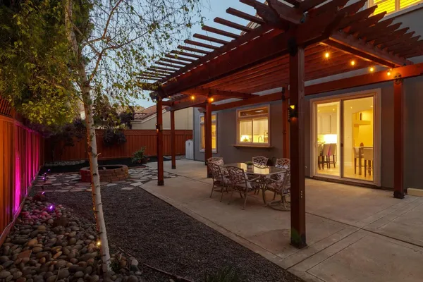 a view of a house with backyard and sitting area