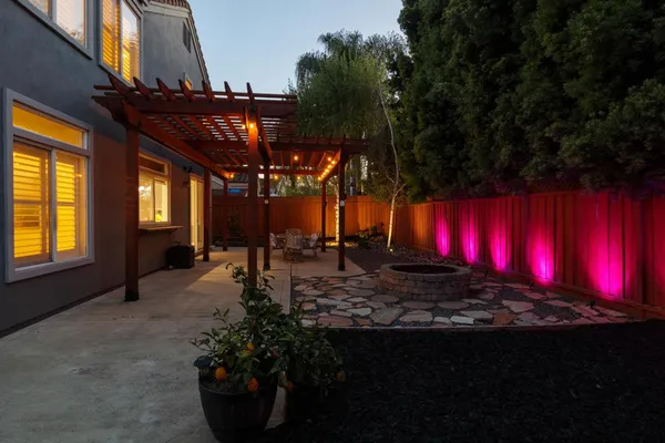 a view of a house with a yard siting area and garden
