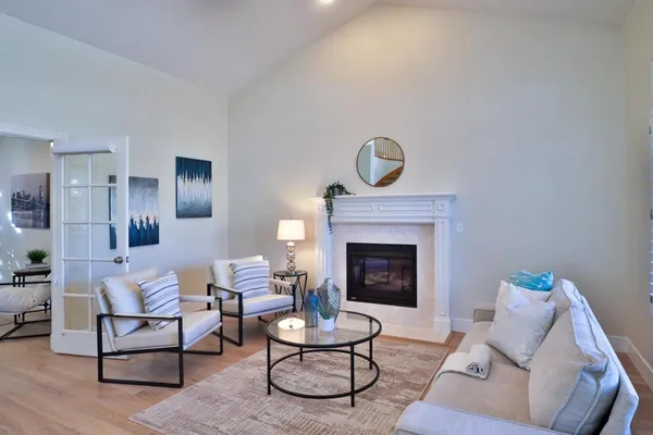 a living room with furniture fireplace and window