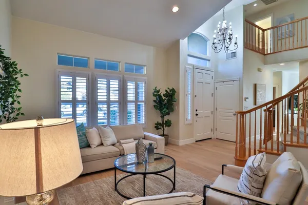 a living room with furniture and a wooden floor