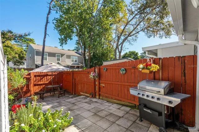 an aerial view of a house with swimming pool and large trees