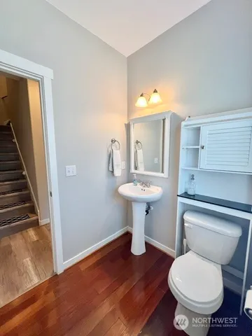 a bathroom with a toilet sink and mirror