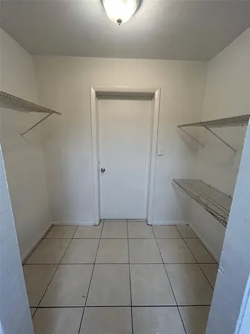 a view of a utility room with closet and racks