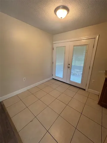 an empty room with a bench and vanity