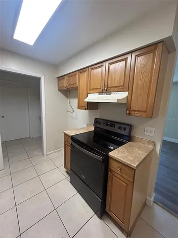 a kitchen with granite countertop a stove and a sink with granite countertops