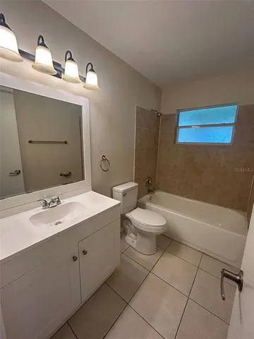 a bathroom with a double vanity sink mirror and toilet
