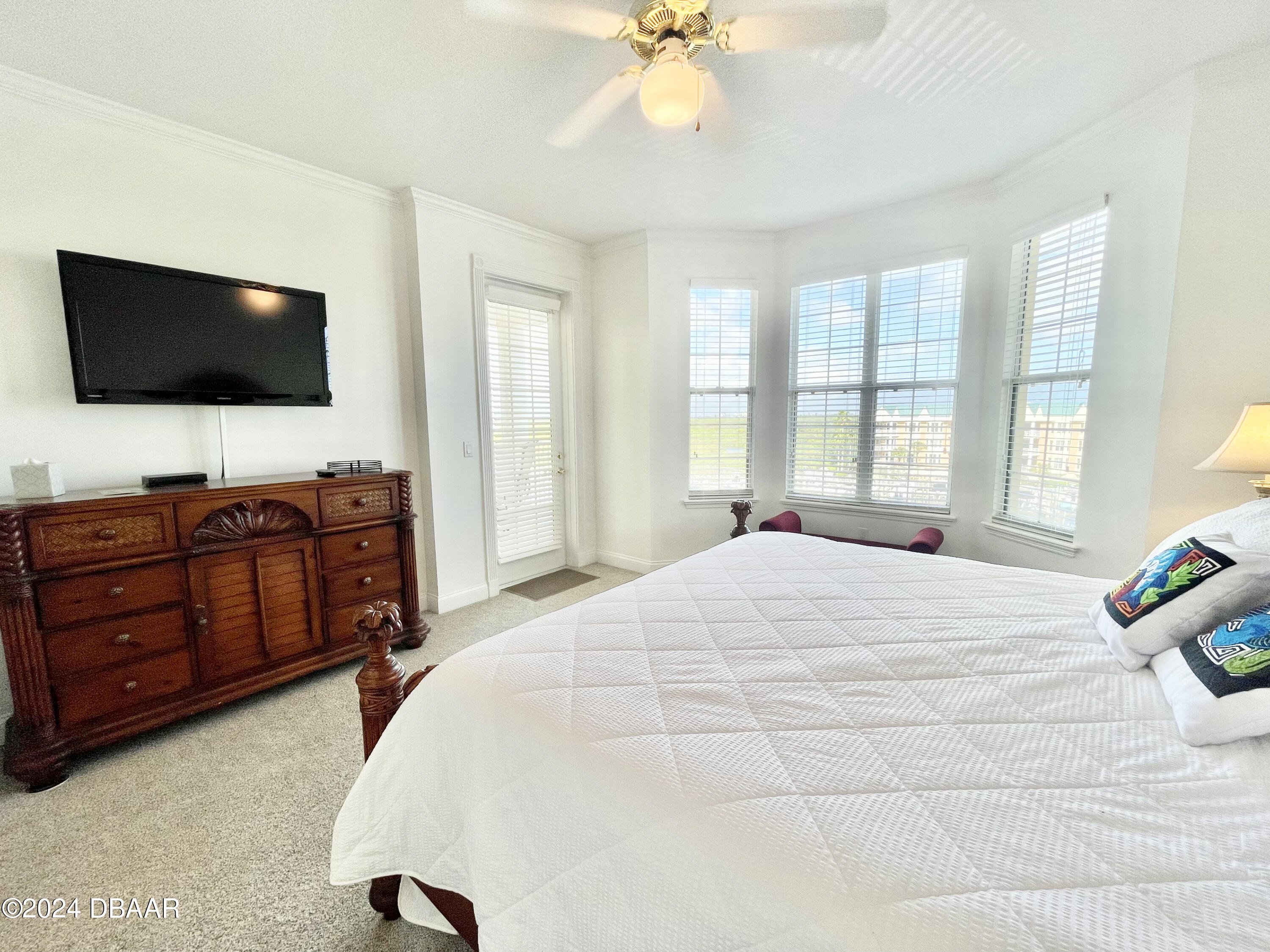 4626 Harbour Village Boulevard, Unit 3505 Ponce Inlet, FL 32127 - Photo 15 of 38 a bedroom with a bed and a flat screen tv