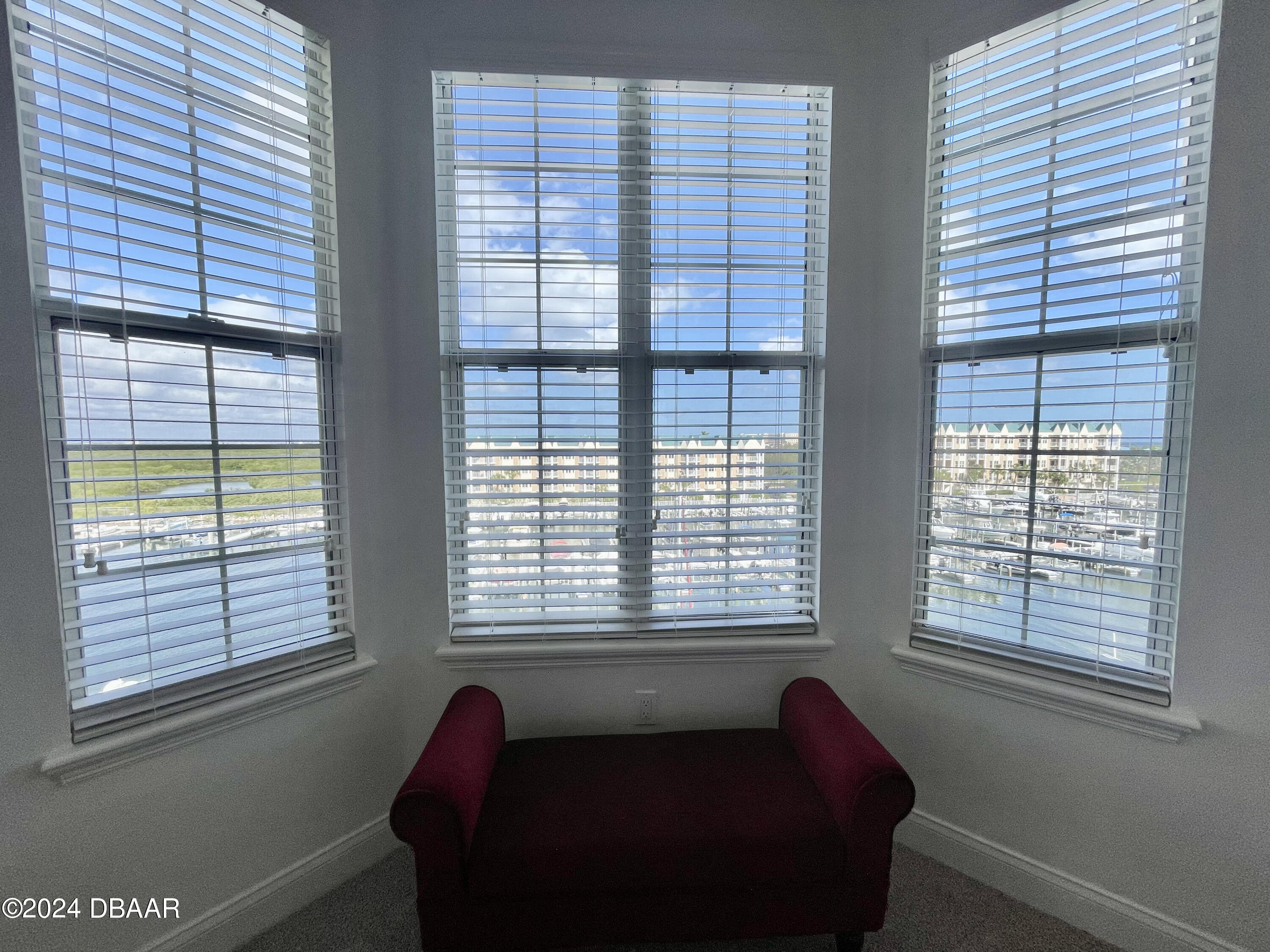 4626 Harbour Village Boulevard, Unit 3505 Ponce Inlet, FL 32127 - Photo 16 of 38 a living room with furniture and a window