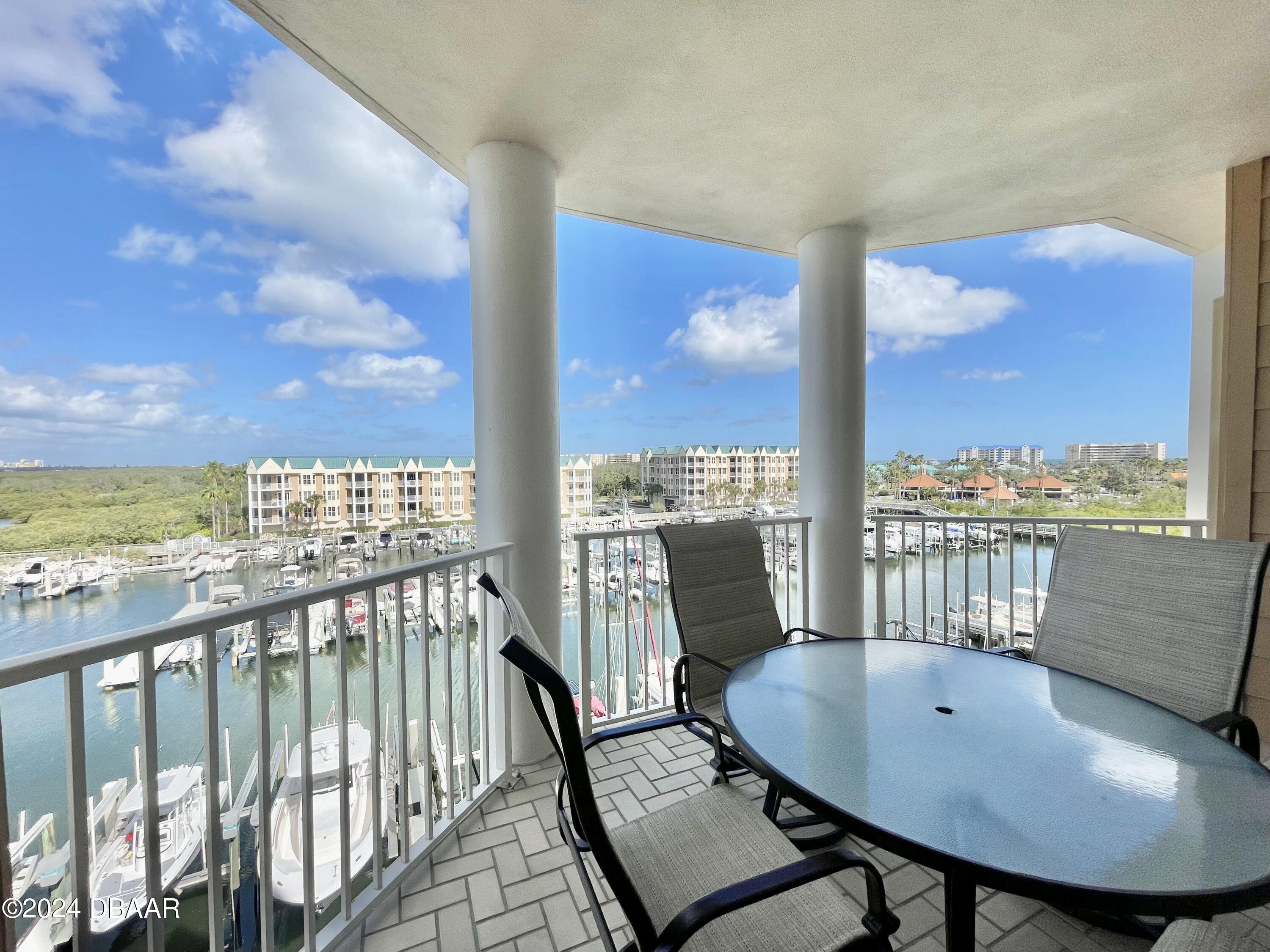 4626 Harbour Village Boulevard, Unit 3505 Ponce Inlet, FL 32127 - Photo 21 of 38 a view of a balcony with a table and chairs