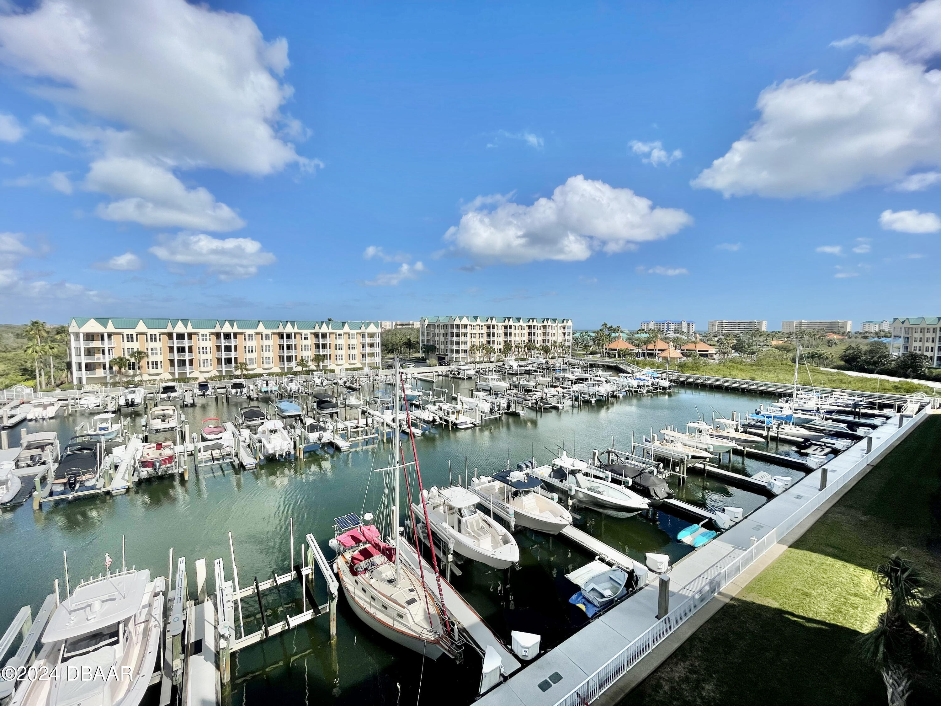 4626 Harbour Village Boulevard, Unit 3505 Ponce Inlet, FL 32127 - Photo 23 of 38 a view of a lake with tall buildings
