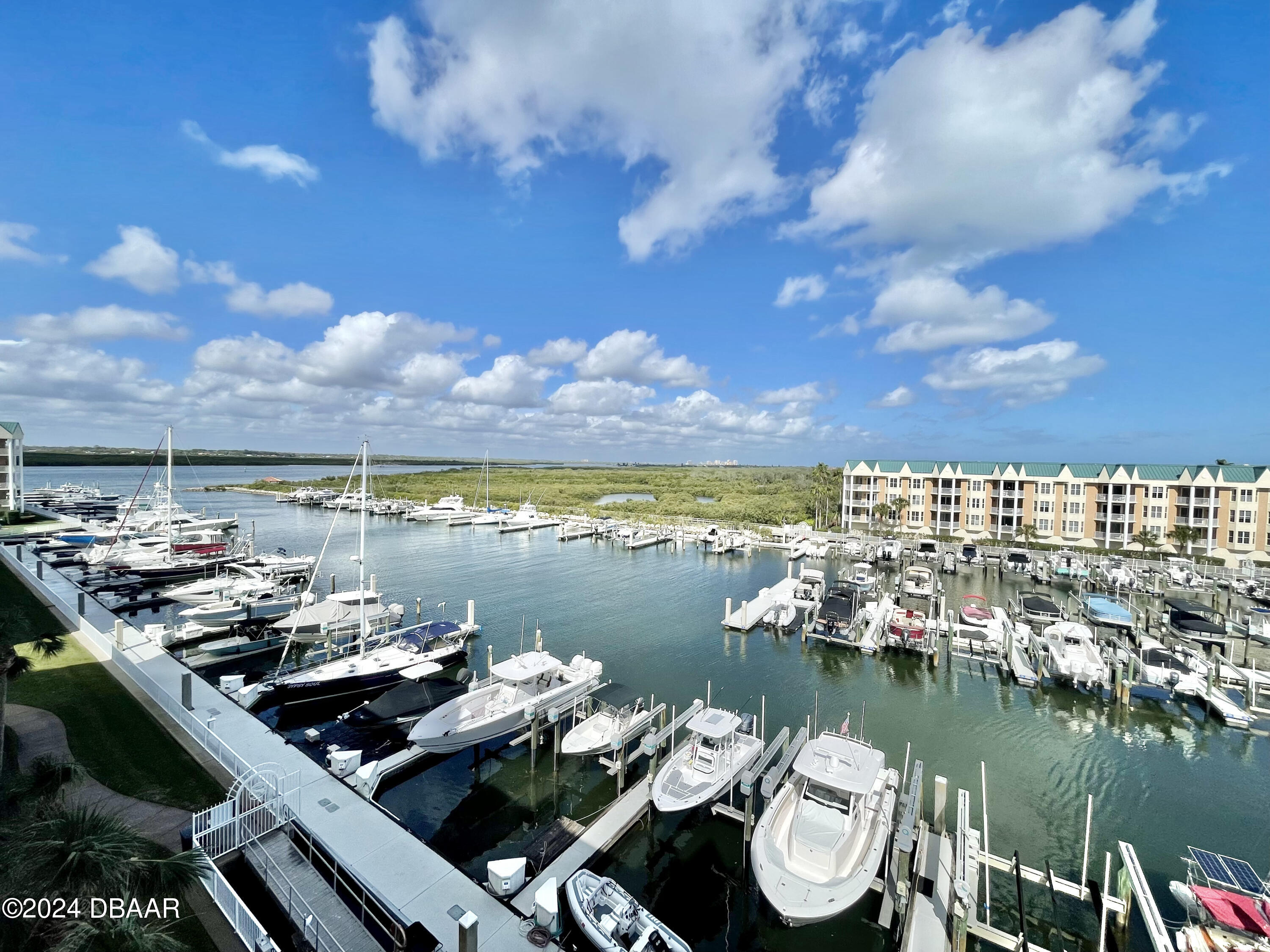 4626 Harbour Village Boulevard, Unit 3505 Ponce Inlet, FL 32127 - Photo 3 of 38 a view of a lake with tall buildings