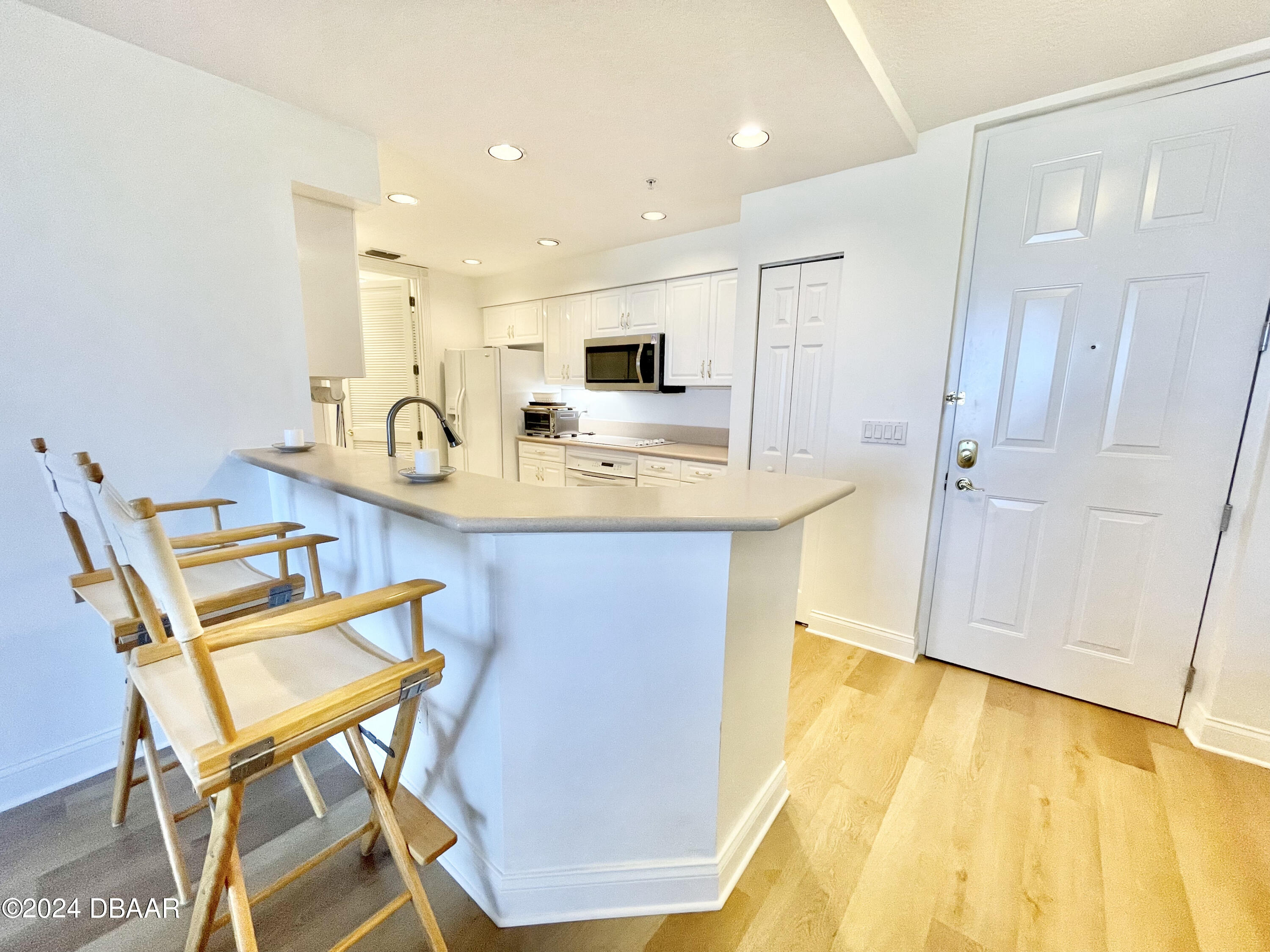 4626 Harbour Village Boulevard, Unit 3505 Ponce Inlet, FL 32127 - Photo 4 of 38 a kitchen with a table and chairs